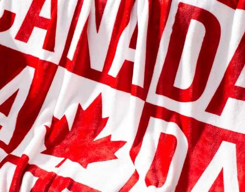 Close-up on the bold red and white design on our Canada Check Fleece Throw.