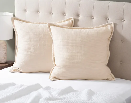 Our Bamboo Gauze Euro Shams in Bone at the head of a bed.
