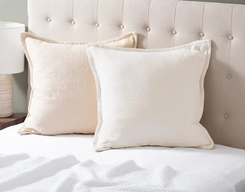 Our Bamboo Gauze Euro Shams in Bone at the head of a bed.