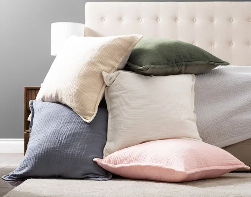 All our Bamboo Gauze Euro Shams piled on a bed.