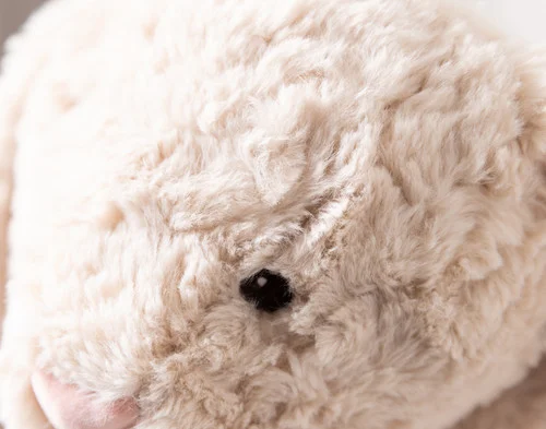 Close-up of the fluffy face of our Large Easter Plush Bunny Cushion.