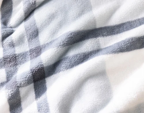 Close-up of the smooth cashmere surface of our Coastline Plaid Blanket.