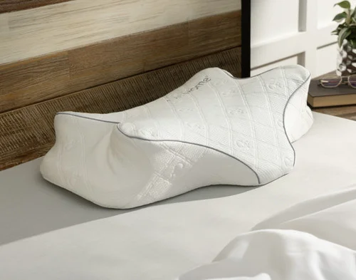 Angled view of our Butterfly Memory Foam Pillow on a white bed.