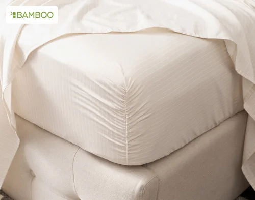 Our Bamboo Cotton Fitted Sheet in Sandy Stripe fitted around the corner of a mattress.