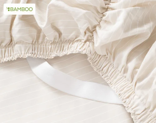 Close-up of the corner STAY SNUG elastics on our Bamboo Cotton Fitted Sheet in Sandy Stripe.