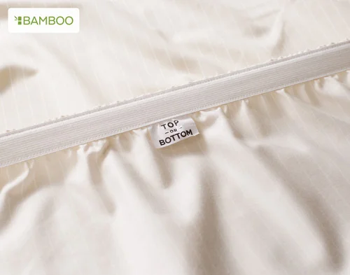 The Top / Bottom tag on our Bamboo Cotton Fitted Sheet in Sandy Stripe.
