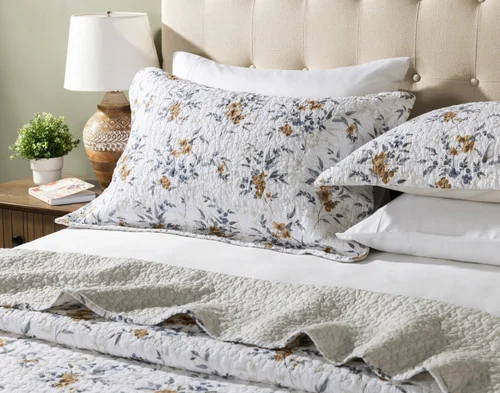 Our Esther Cotton Quilt Set decorating the head of a bed.