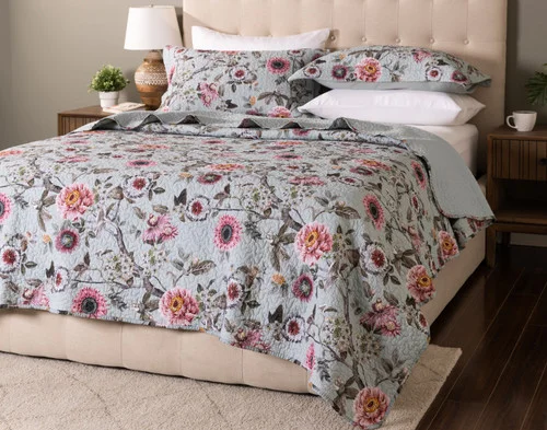 Angled view of our Eloise Cotton Quilt Set dressing a queen bed in a modern bedroom.