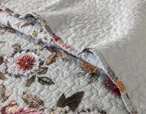 Close up on the folded surface of our Eloise Cotton Quilt Set to show the main and reverse designs.