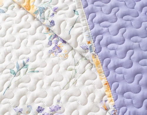 Close-up on a folded edge on our Clara Coverlet Set.