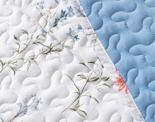 Close-up on a folded edge on our Delphine Coverlet Set.