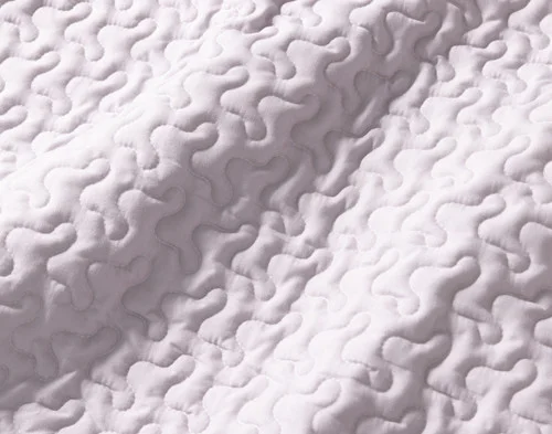 Close-up of the solid grey reverse on our Niko Coverlet Set.