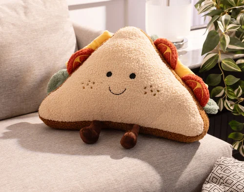 Our Sammy Sandwich Cushion lying on a couch.