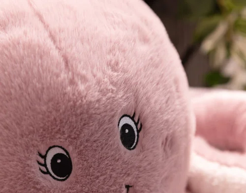 Close up on the smiling face on our Octavia Octopus Cushion.