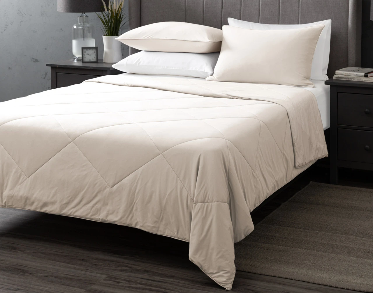 Our Cloudstone Cool Touch Blanket dressed over a white bed with coordinating pillowcases.