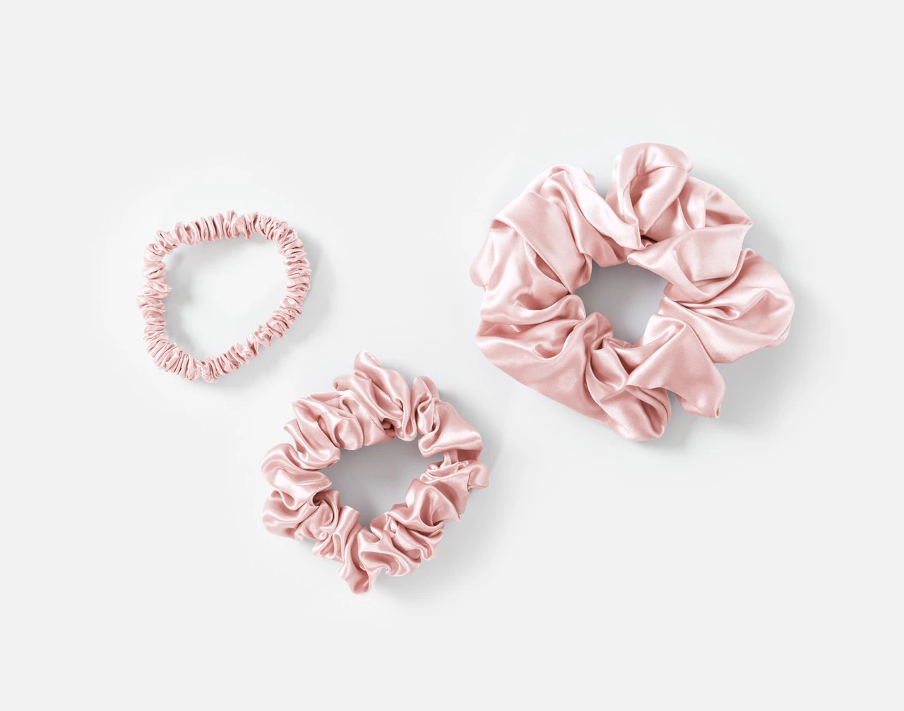 Top view of the small, medium and large scrunchies in our Blush Mulberry Silk Scrunchie Set.