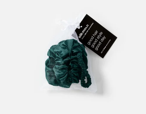 Top view of the mesh bag packaging holding our Green Mulberry Silk Scrunchie Set.