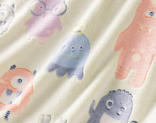 Close-up on the etched designs on our Snuggle Monsters Glow In The Dark Throw.