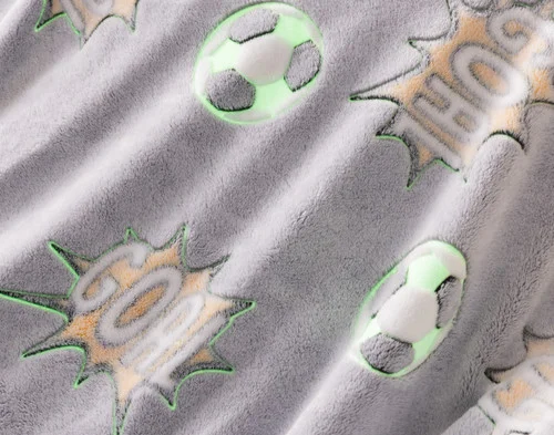 Close-up on the etched designs on our Kickoff Glow In The Dark Throw with outlines to show its glowing spots.