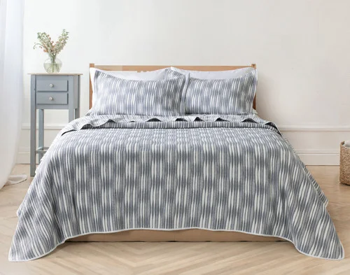 Front view of our Tidemark Quilt Set dressed over an empty queen bed.