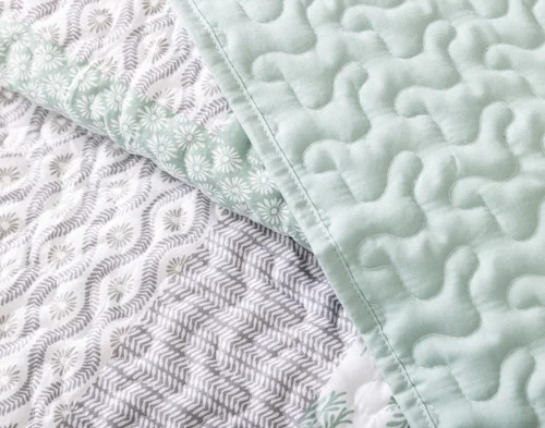 Close-up on a folded edge on our Nora Coverlet Set.