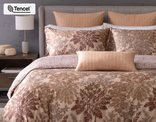 Front, off-centre view of our Henna Leaf Duvet Cover dressing a queen bed in a simple bedroom.
