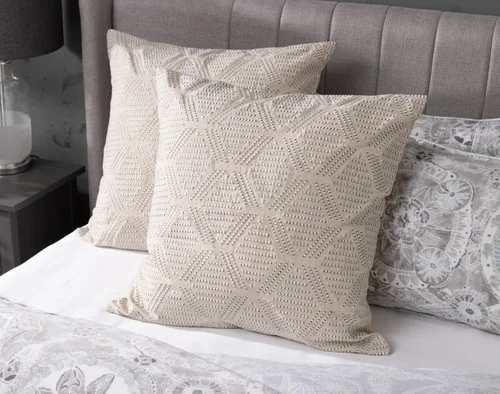 Our Romano Euro Shams decorating the head of a bed.