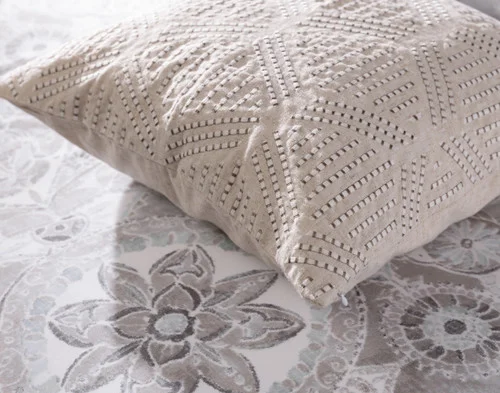 Close up on the side of our Romano Square Cushion Cover atop our Romano Duvet Cover.