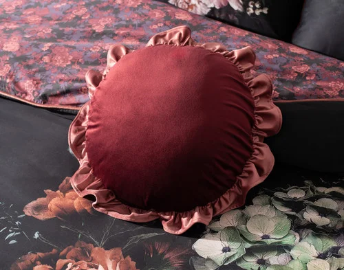 Our Valentina Round Cushion resting atop our Valentina Duvet Cover.