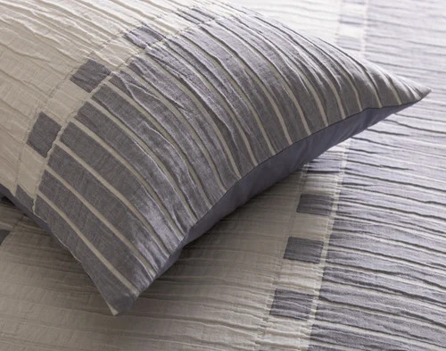Corner of our Rocco Pillow Sham resting atop our Rocco Duvet Cover.