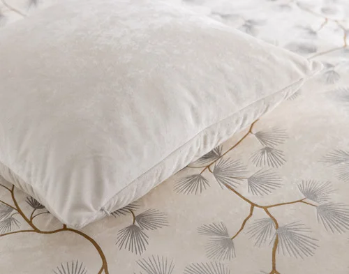 Close up on our Silverbough Square Cushion Cover laying on a bed with our Silverbough collection.