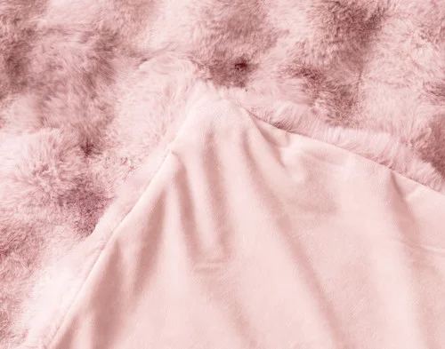 The folded corner of our Bubble Faux Fur Throw in Peony.