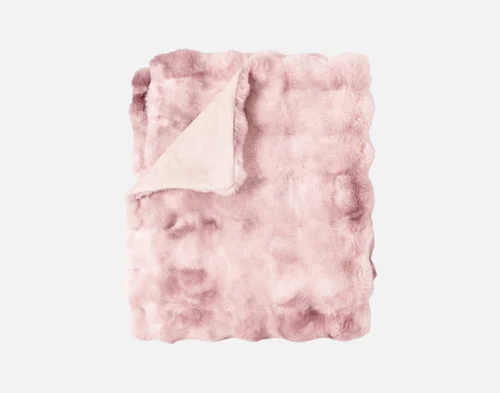 Our Bubble Faux Fur Throw in Peony folded into a rectangle.