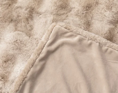 The folded corner of our Bubble Faux Fur Throw in Champagne.