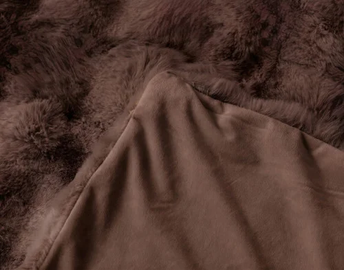 The folded corner of our Bubble Faux Fur Throw in Truffle.