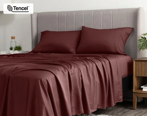 Angled view of a queen bed dressed in our BeechBliss TENCEL™ Modal Sheet Set in Mahogany.