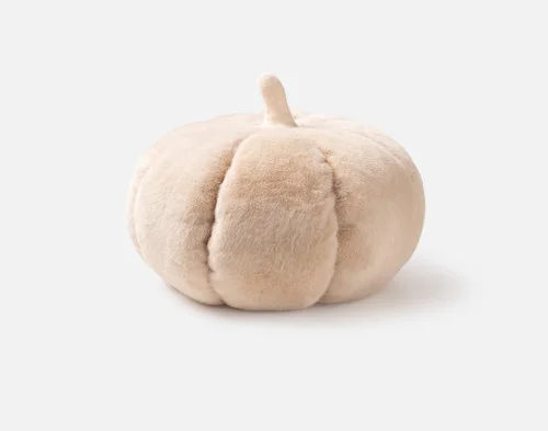 Side view of our Pumpkin Cushion in Custard sitting against a solid white background.