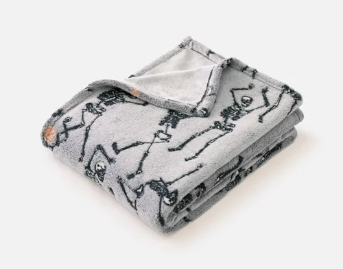 Our Skeleton Crew Glow in the Dark Fleece Throw folded into a tidy square.