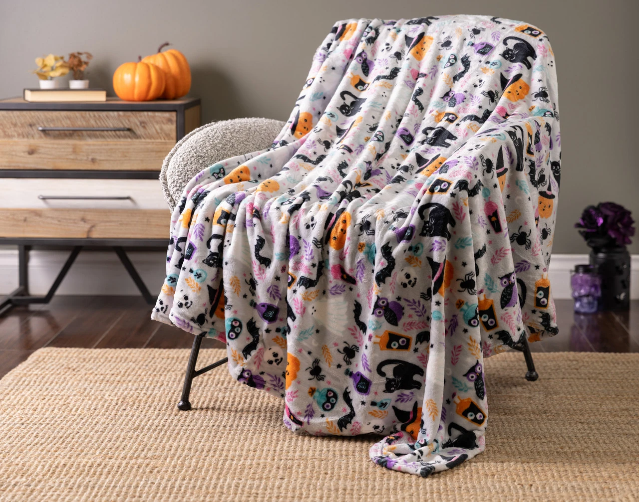 Our Midnight Mischief Halloween Fleece Throw draped over a chair.