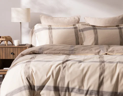 Front, off-centre view of our Bowen Duvet Cover Set dressing a queen bed in a simple modern room.