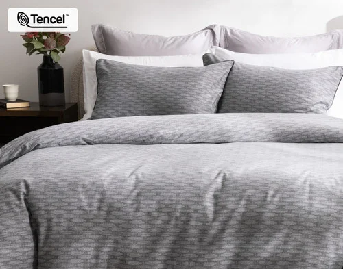 Front, off-centre view of our Metric Duvet Cover decorating a queen bed in a simple bedroom.