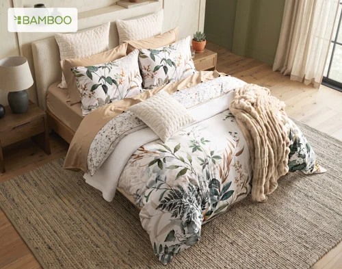 Angled, top-down view of our Cabot Duvet Cover dressing a queen bed with accessories.