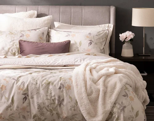 Front, off-centre view of our Elodie Duvet Cover dressing a queen bed with accessories.
