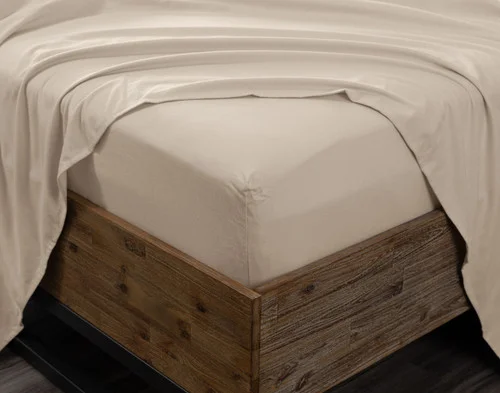 Angled view of the corner on a mattress wrapped in our Toasted Oat Flannel Sheet Set.