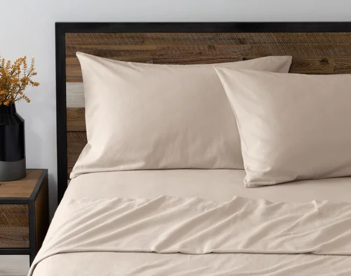Front view of two pillowcases from our Toasted Oat Flannel Sheet Set leaning against a headboard.