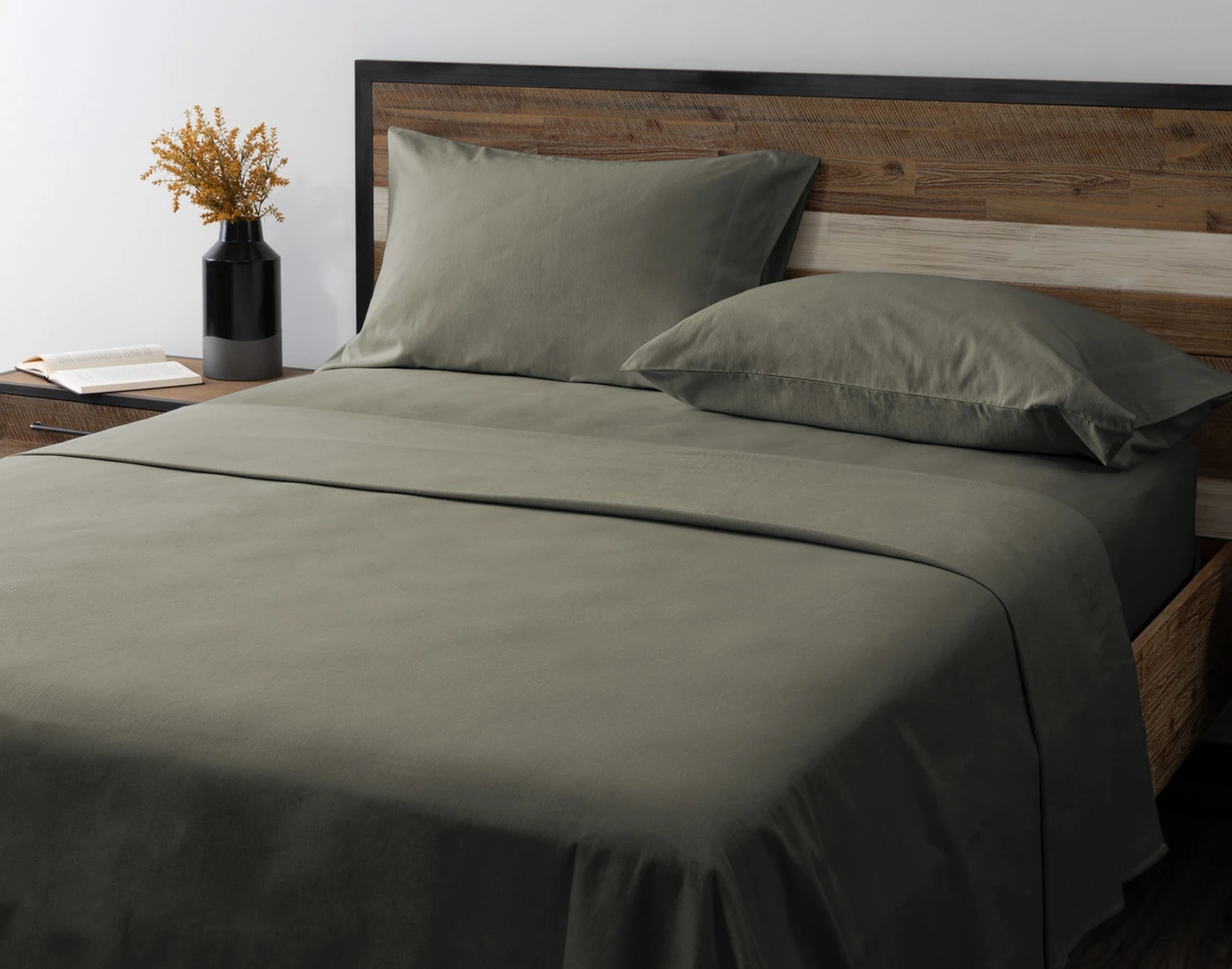 Angled view of our Alpine Forest Flannel Sheet Set dressed over an empty queen bed.