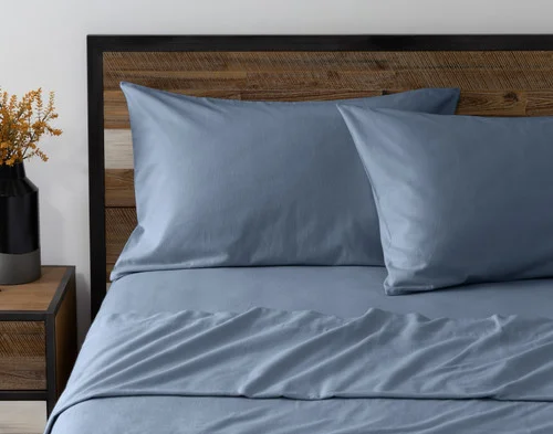 Front view of two pillowcases from our Arctic Slate Flannel Sheet Set leaning against a headboard.
