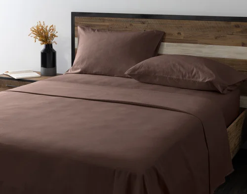 Angled view of our Rustic Woods Flannel Sheet Set dressed over an empty queen bed.