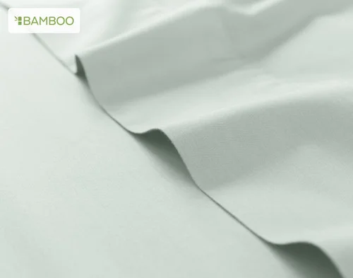 Our Bamboo Cotton Flat Sheet in Thyme atop our Bamboo Cotton Fitted Sheet in Aqua Smoke.