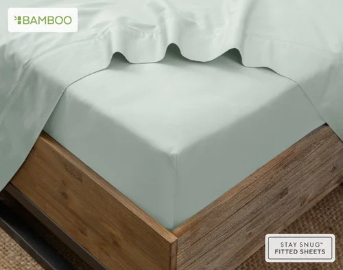 The corner of a bed with our Bamboo Cotton Flat Sheet in Aqua Smoke atop our Bamboo Cotton Fitted Sheet in Aqua Smoke.